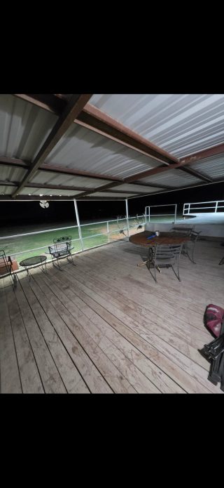 The fully lit back porch at BarBell Ranch offers a relaxing space for fellowship and conversation after a day of hunting.