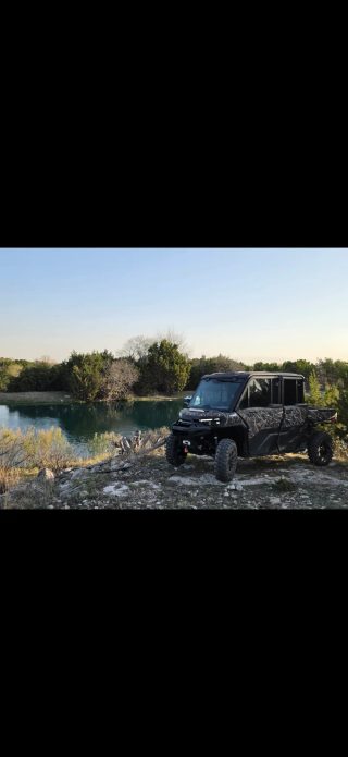 A UTV sits beside a water feature at BarBell Ranch in Sweetwater, TX.