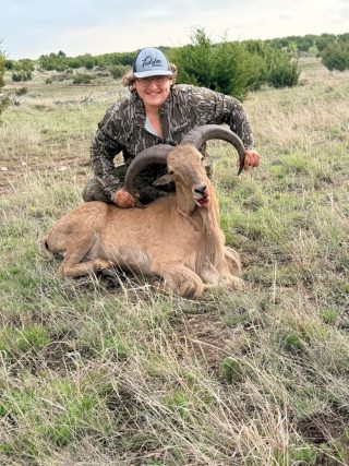 A hunter with her BarBell Ranch Aoudad Trophy in Sweetwater, TX.
