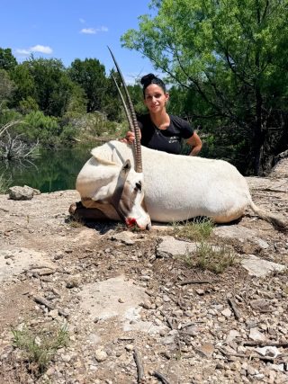 Hunter with an Arabian Oryx taken at BarBell Ranch in Sweetwater, TX beside a pond.