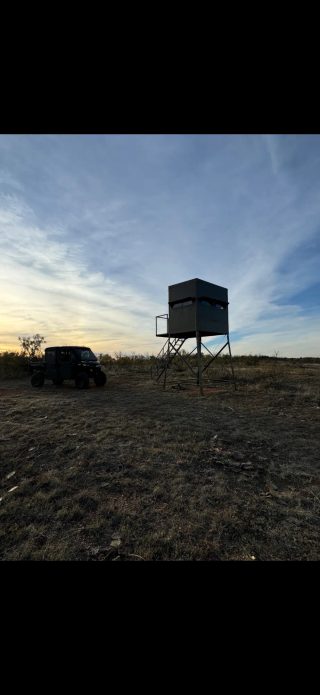 A side-by-side UTV and a hunting blind at BarBell Ranch in Sweetwater, TX, at sunrise.