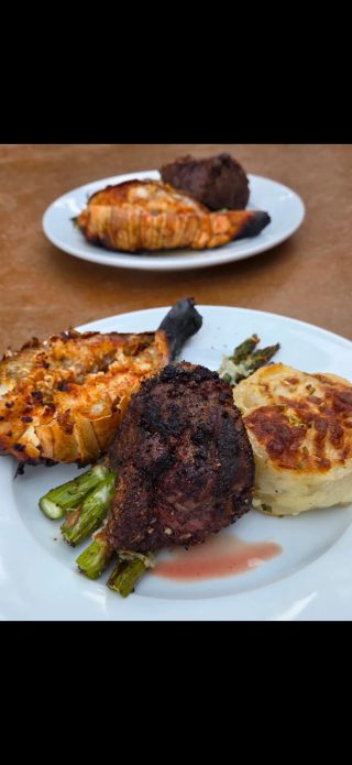 Grilled lobster, steak, and vegetables served as part of the lodging experience at BarBell Ranch.