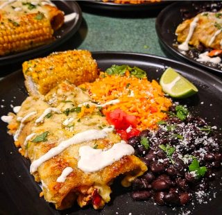 Grilled corn, enchiladas, rice, and beans, a meal prepared for guests at BarBell Ranch.