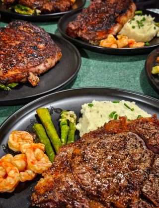 Prime steak and shrimp with asparagus and mashed potatoes exemplifies BarBell Ranch dining.