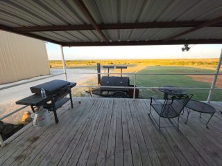 The porch and grill area at BarBell Ranch in Sweetwater, TX, offers expansive views of West Texas.
